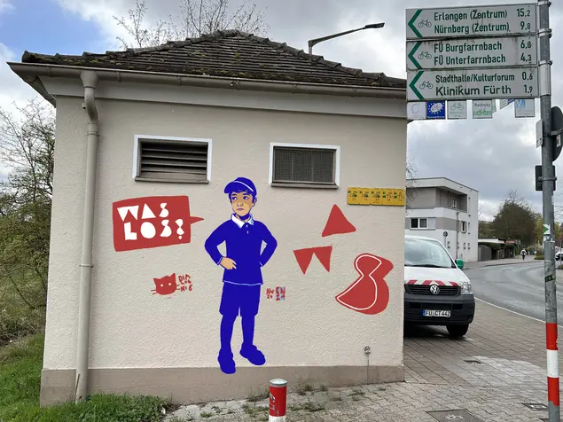 Graffitti mit Jungem und Sprechblase "Was los?"