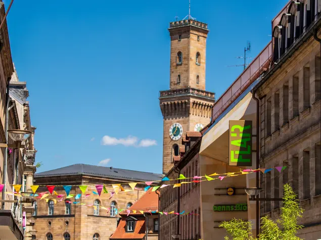 Blick von der mit Wimpeln geschmückten Fußgängerzone auf das Rathaus 