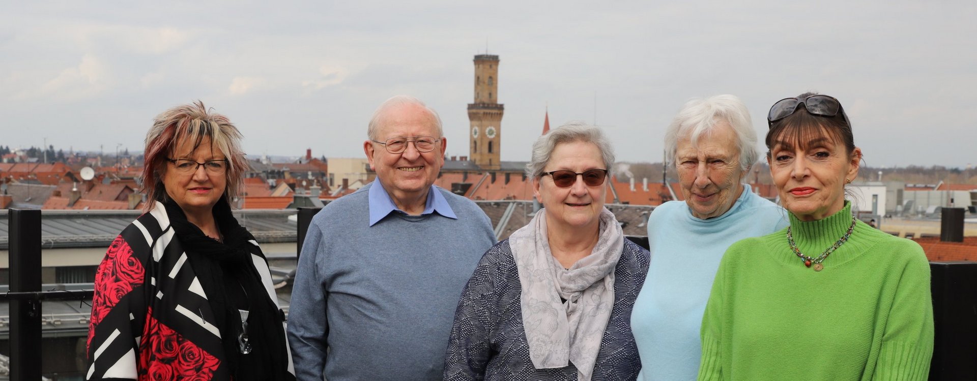 Die Mitglieder des Seniorenrats vor der Stadtkulisse mit Rathausturm im Hintergrund