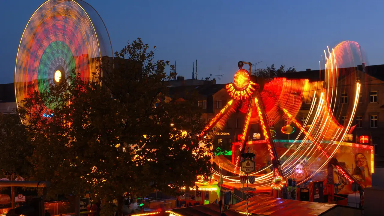 Michaelis-Kirchweih mit Riesenrad und Fahrgeschäft bei Dunkelheit