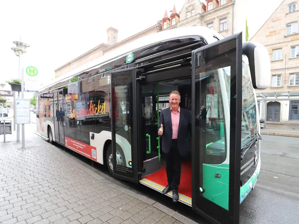 OB Jung vor einem E-Bus der infra fürth, Klickt zeigt Bild in größerer Darstellung.